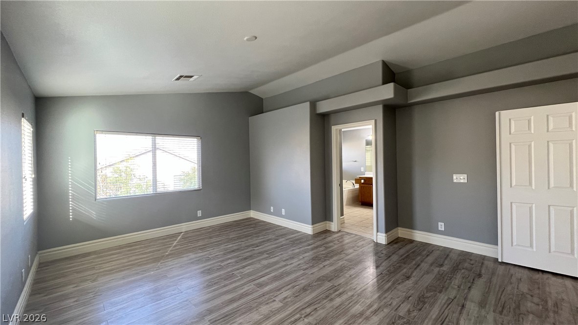 258 Rustic Club Way Las Vegas, NV 89148 - Photo 13 of 25 This primary bedroom features durable flooring, offering a blank canvas for personalization.