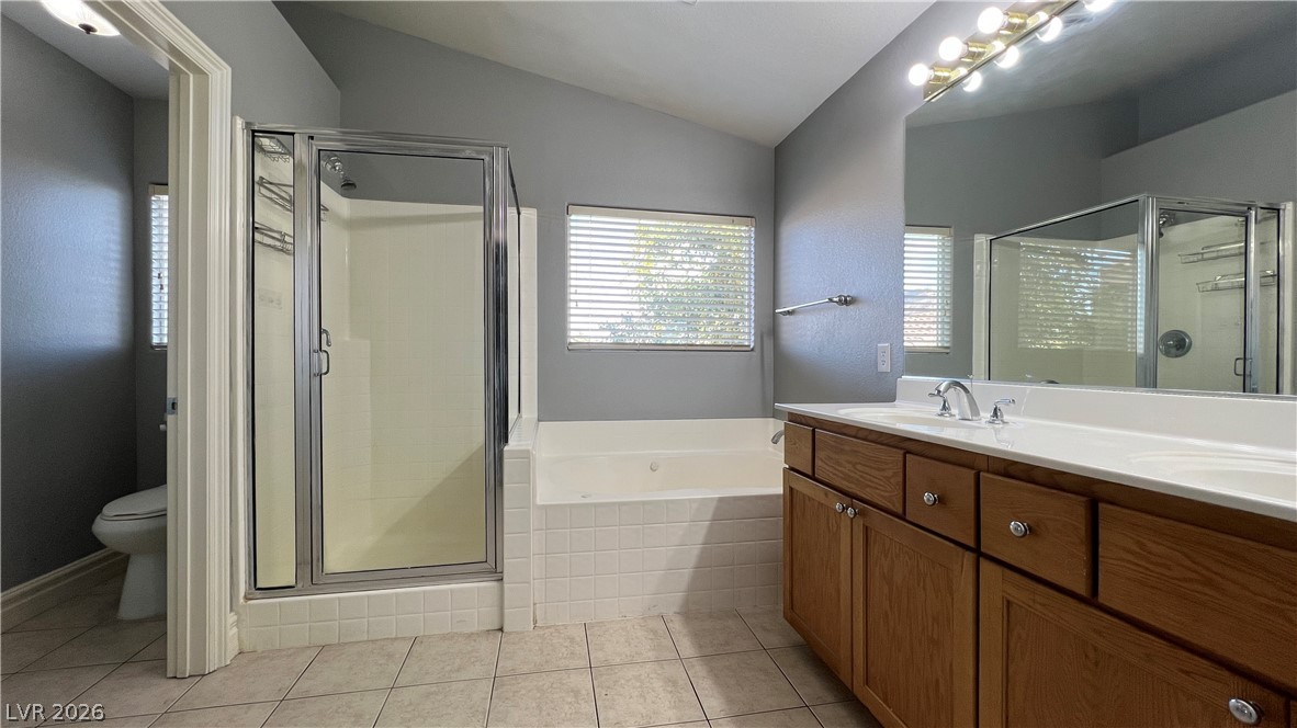 258 Rustic Club Way Las Vegas, NV 89148 - Photo 15 of 25 This spacious bathroom offers a double vanity and a separate shower and soaking tub, ideal for unwinding.
