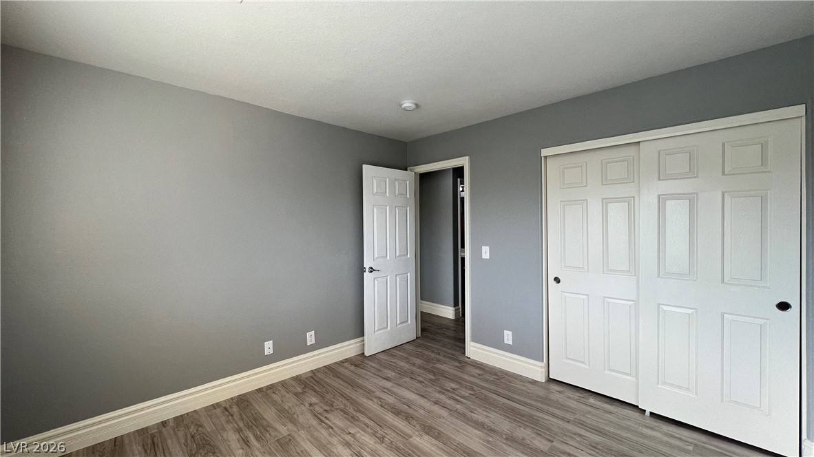 258 Rustic Club Way Las Vegas, NV 89148 - Photo 19 of 25 This spacious bedroom features durable flooring and ample closet space, ready for personalization.