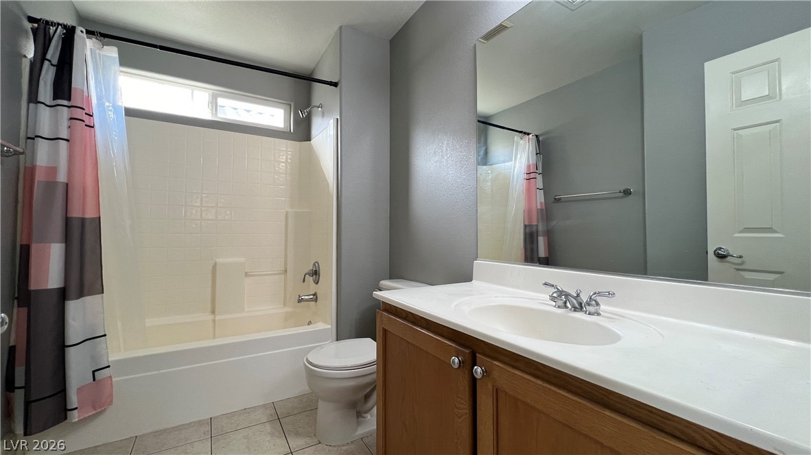 258 Rustic Club Way Las Vegas, NV 89148 - Photo 20 of 25 This clean bathroom features a convenient shower-tub combination and a practical vanity with ample storage.