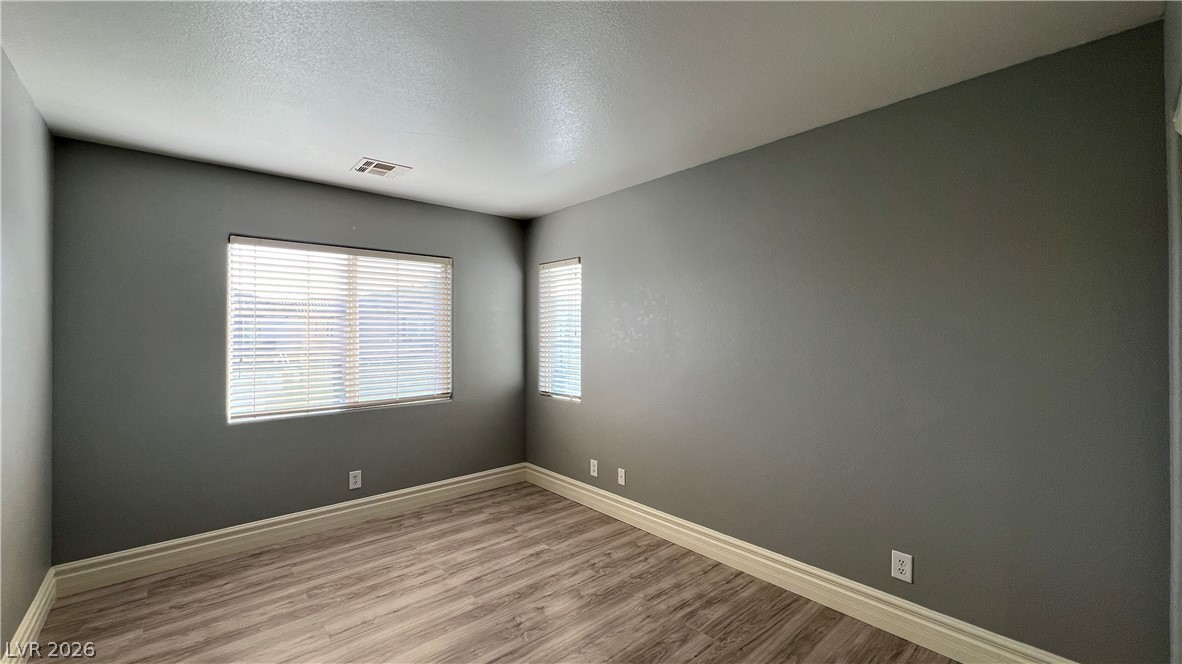 258 Rustic Club Way Las Vegas, NV 89148 - Photo 21 of 25 This bright room features durable laminate flooring and inviting natural light.