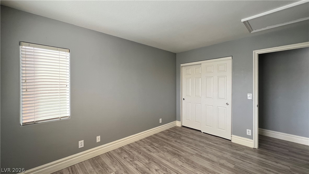 258 Rustic Club Way Las Vegas, NV 89148 - Photo 22 of 25 This inviting bedroom features durable flooring, a convenient closet, and natural light.
