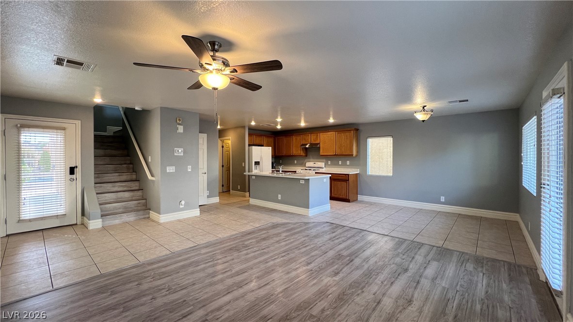 258 Rustic Club Way Las Vegas, NV 89148 - Photo 25 of 25 This inviting interior features an open floorplan with a kitchen island, perfect for gatherings.