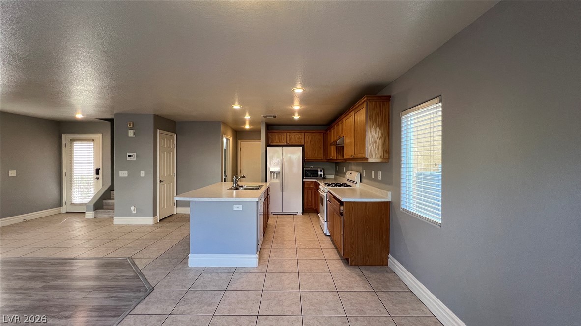 258 Rustic Club Way Las Vegas, NV 89148 - Photo 6 of 25 This functional kitchen features ample counter space and offers a seamless connection to adjacent living areas.