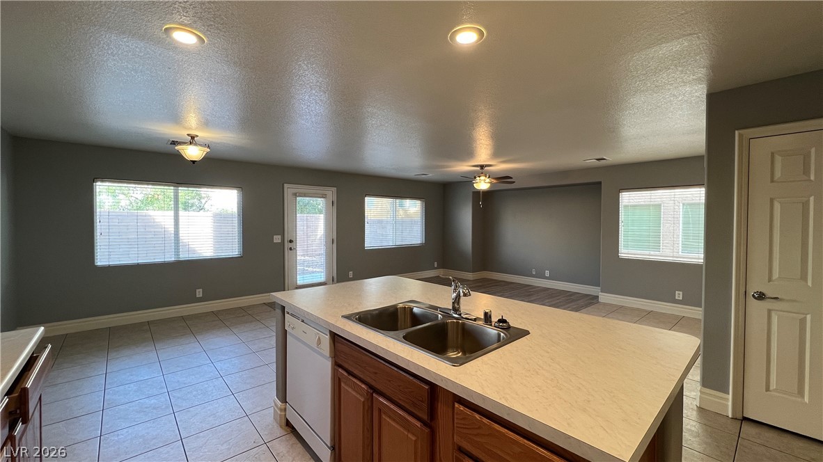 258 Rustic Club Way Las Vegas, NV 89148 - Photo 7 of 25 This bright and airy open-concept space features a kitchen island, seamlessly connecting living areas.