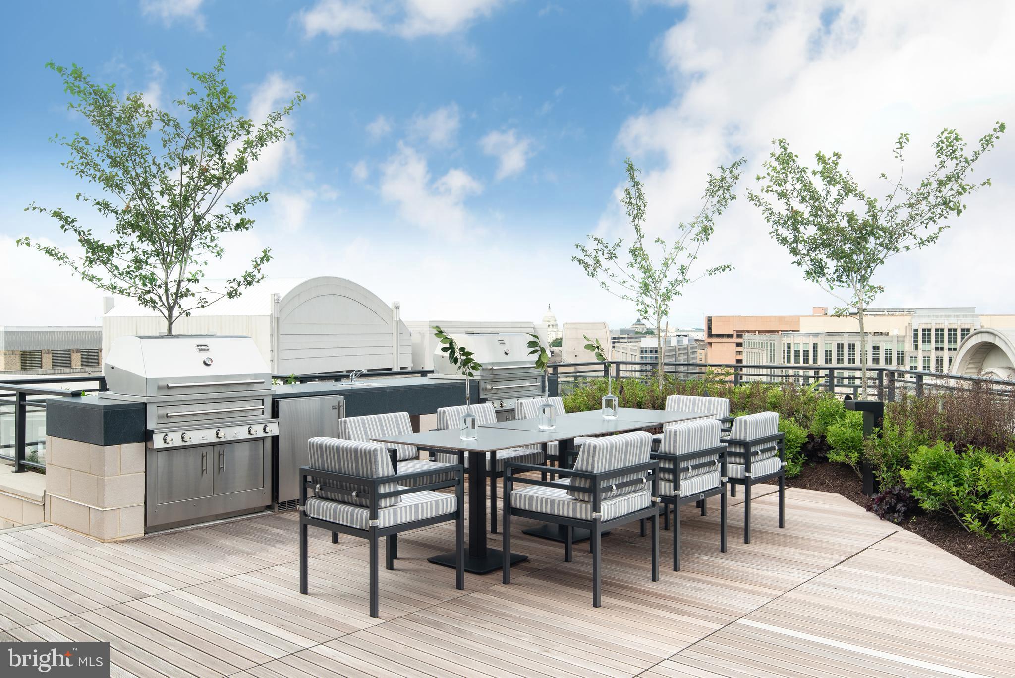 1331 Maryland Avenue Southwest, Unit PH02/VARIES Washington, DC 20024 - Photo 8 of 16 a view of a terrace with furniture and garden