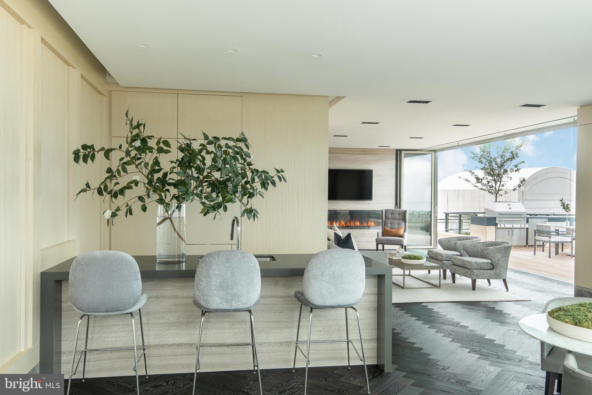 1331 Maryland Avenue Southwest, Unit PH02/VARIES Washington, DC 20024 - Photo 9 of 16 a living room with chairs kitchen view and a large window