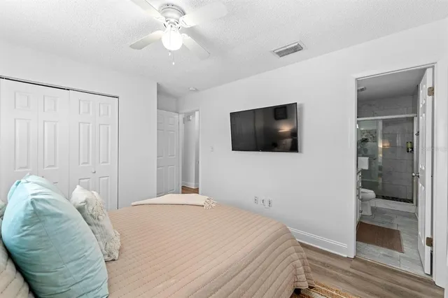 a bedroom with a bed and a flat screen tv