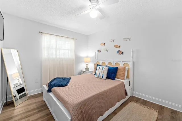 a bedroom with a bed and a chandelier