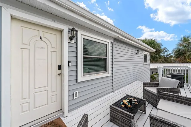 a view of a balcony with furniture and floor to ceiling window