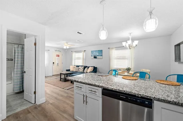 a kitchen with sink and chandelier