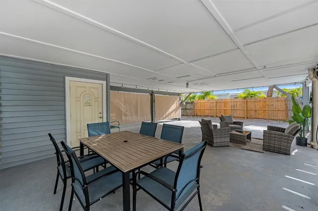 a view of backyard with outdoor seating a patio and a garden