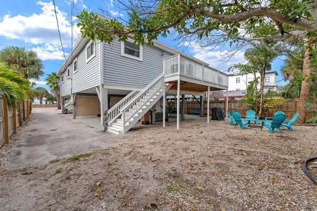 a view of a house with a yard and sitting area