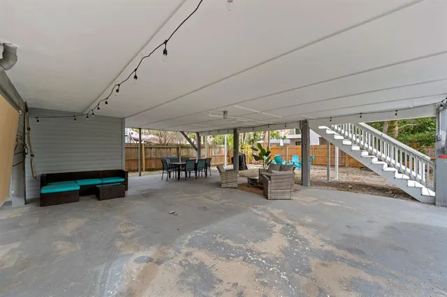 a view of a big room with wooden floor and furniture