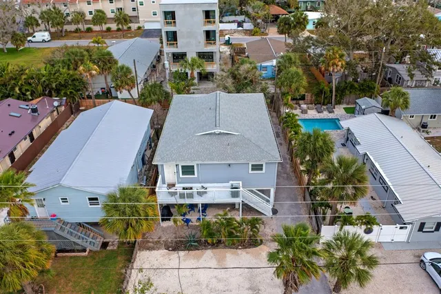 an aerial view of multiple houses with yard