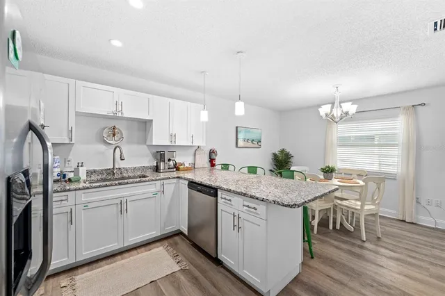 a kitchen with a sink window and cabinets
