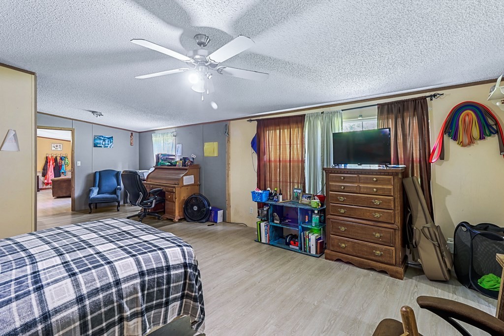 2676 South Riverbend Road Dalton, GA 30721 - Photo 16 of 28 a bed room with furniture and a flat screen tv