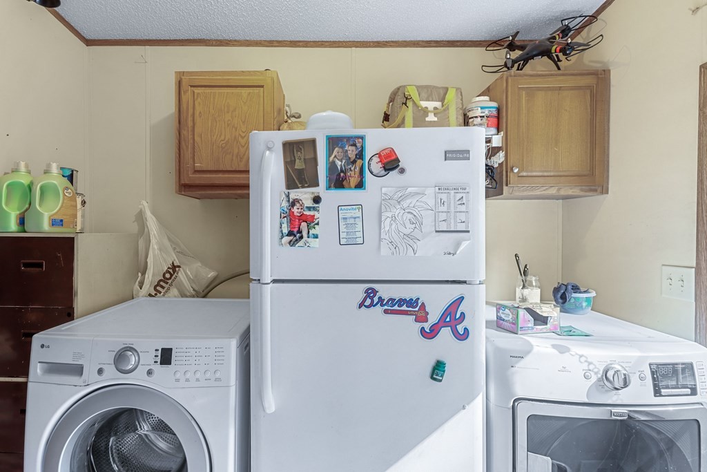 2676 South Riverbend Road Dalton, GA 30721 - Photo 18 of 28 a utility room with dryer and washer