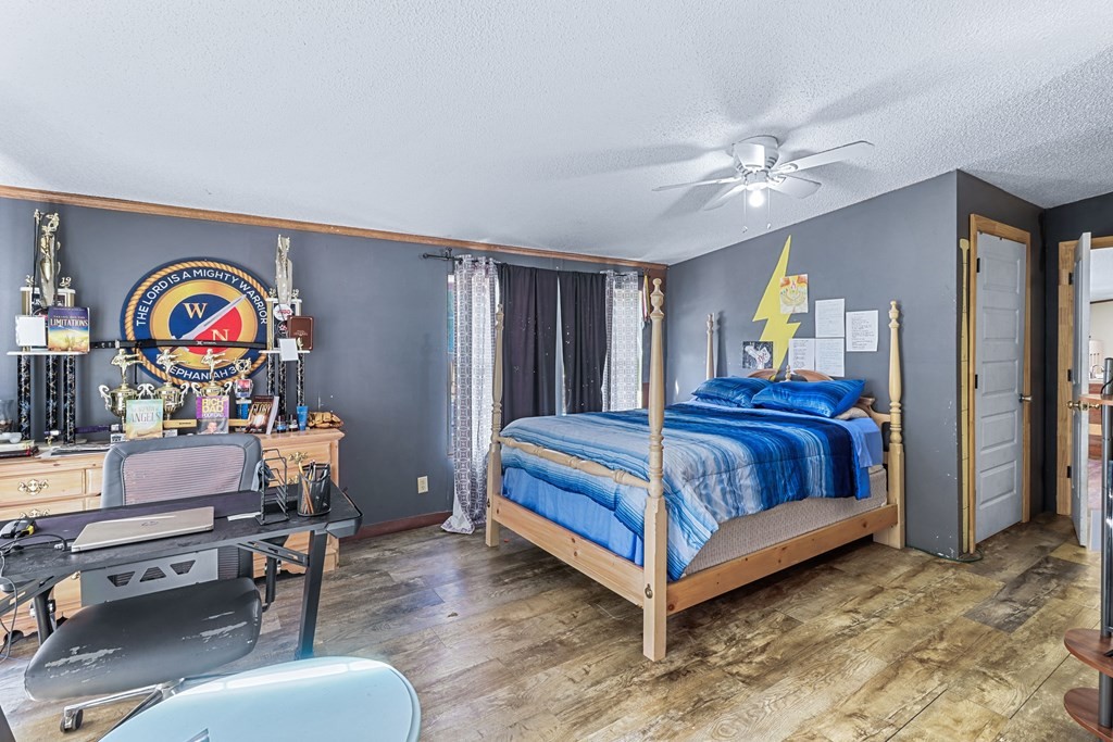 2676 South Riverbend Road Dalton, GA 30721 - Photo 20 of 28 a bedroom with a bed and a chandelier