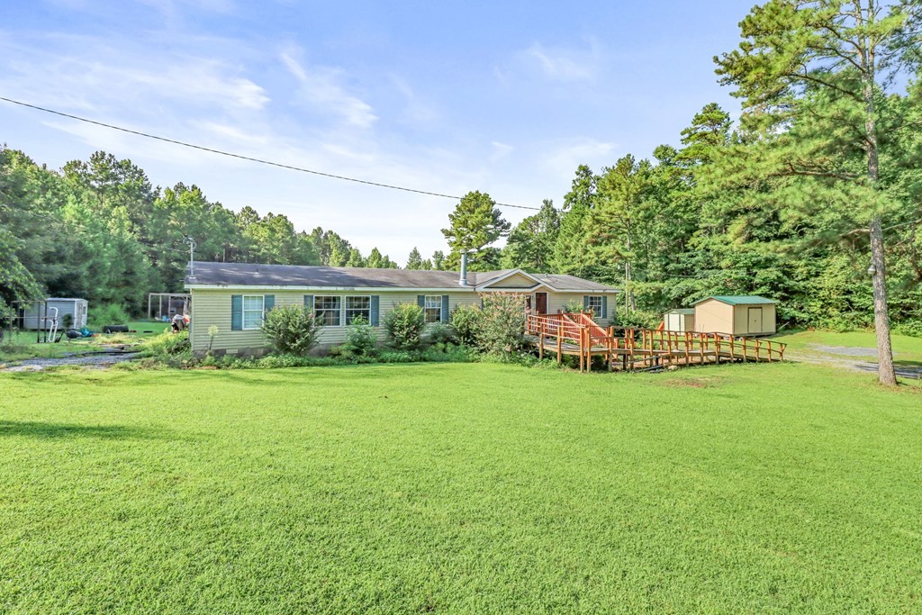 2676 South Riverbend Road Dalton, GA 30721 - Photo 2 of 28 a front view of a house with garden