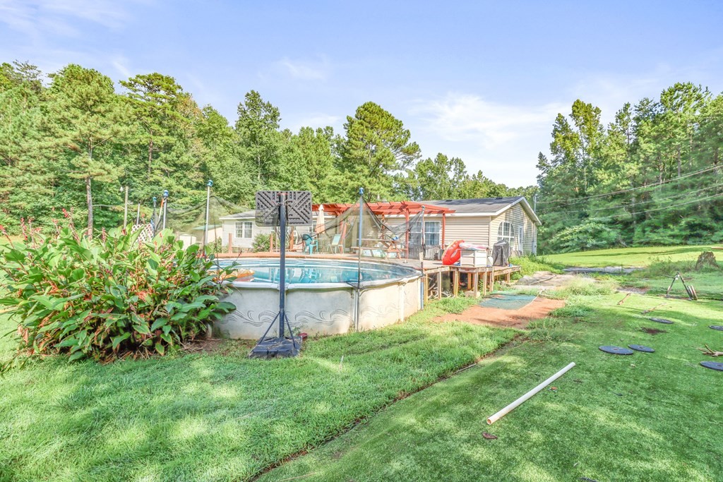 2676 South Riverbend Road Dalton, GA 30721 - Photo 21 of 28 a view of house with backyard and swimming pool