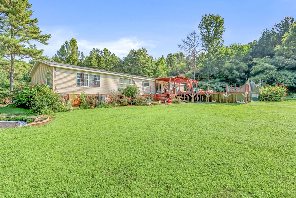 2676 South Riverbend Road Dalton, GA 30721 - Photo 23 of 28 a house view with swimming pool and garden