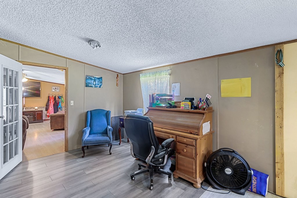 2676 South Riverbend Road Dalton, GA 30721 - Photo 25 of 28 a view of a workspace with furniture and a livingroom