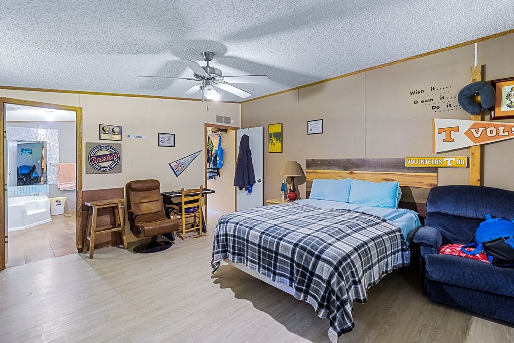 2676 South Riverbend Road Dalton, GA 30721 - Photo 26 of 28 a bedroom with a bed a couch and dresser
