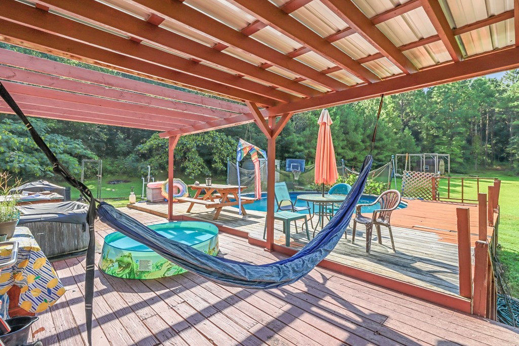 2676 South Riverbend Road Dalton, GA 30721 - Photo 28 of 28 a view of a patio with a table chairs and wooden floor