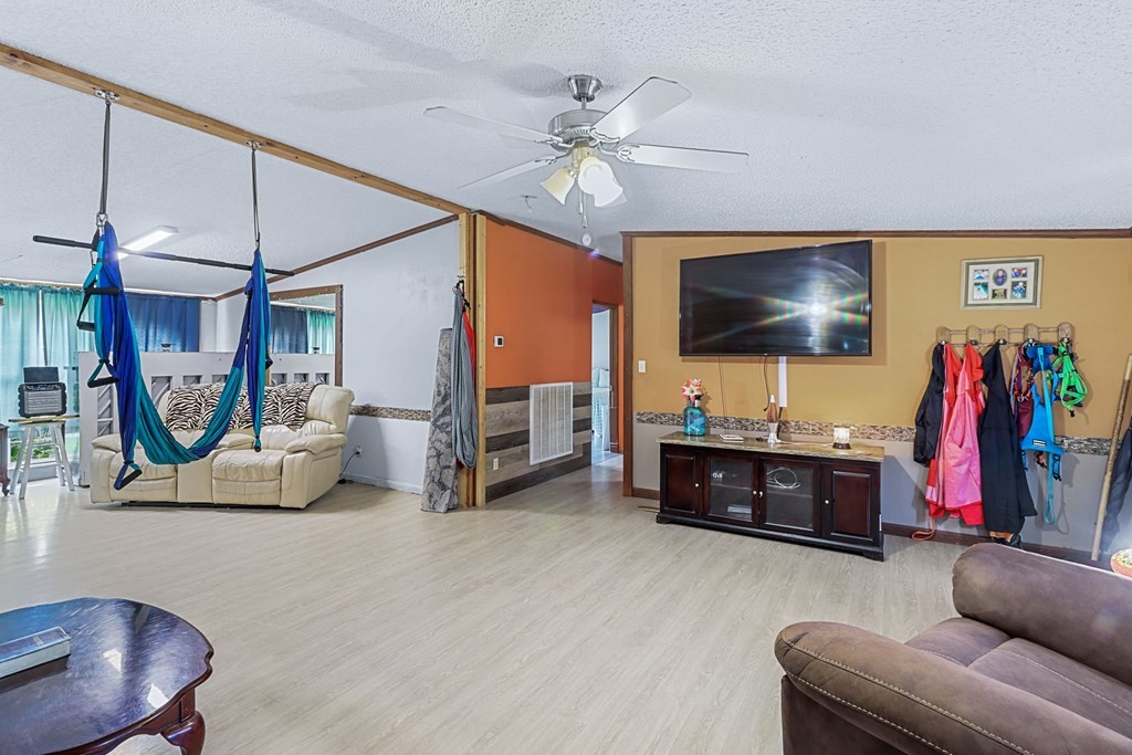 2676 South Riverbend Road Dalton, GA 30721 - Photo 9 of 28 a living room with furniture and a flat screen tv