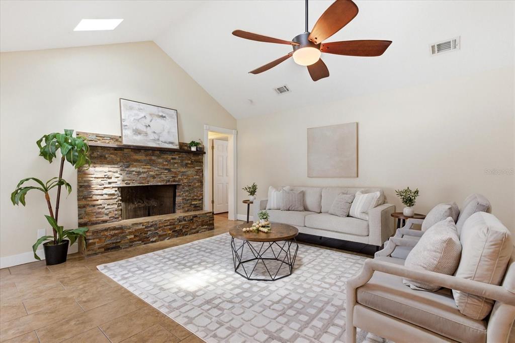 393 Wekiva Cove Road Longwood, FL 32779 - Photo 13 of 49 a living room with furniture and a fireplace