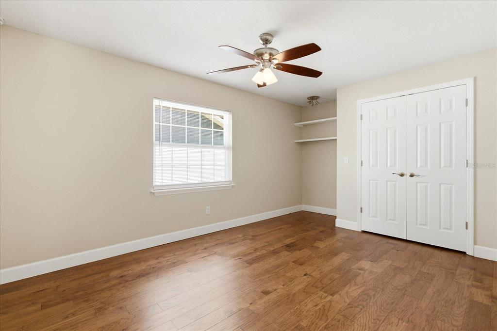 393 Wekiva Cove Road Longwood, FL 32779 - Photo 25 of 49 a view of an empty room with wooden floor and a window