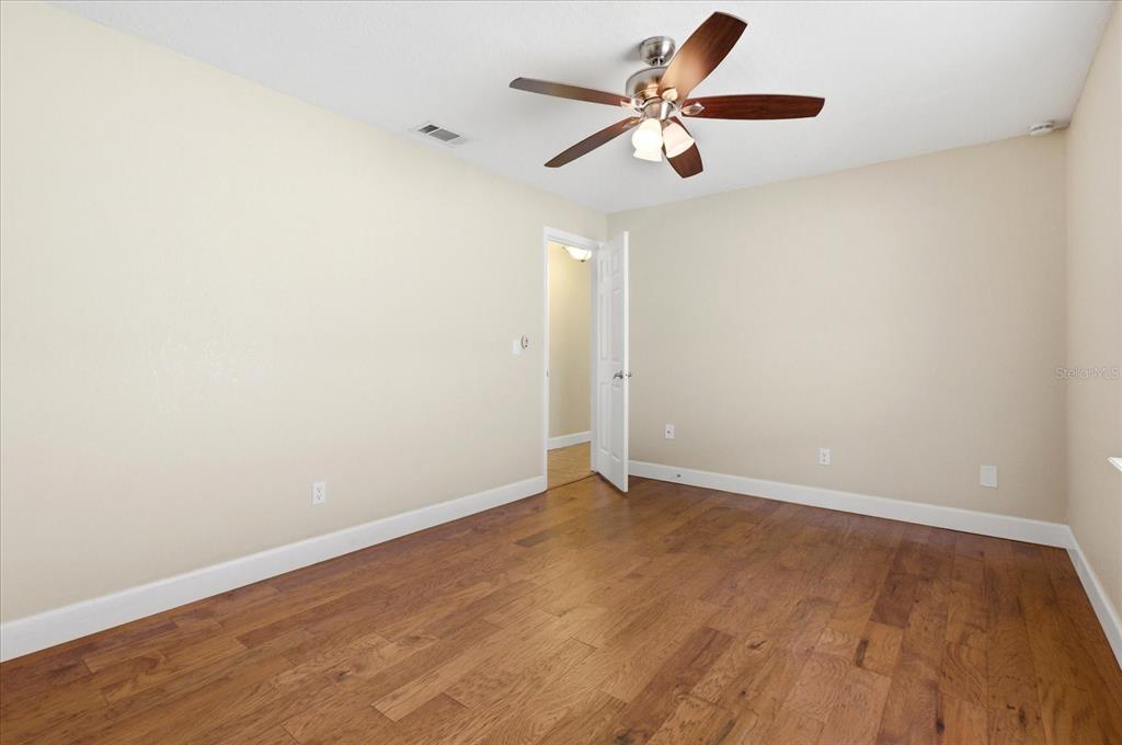 393 Wekiva Cove Road Longwood, FL 32779 - Photo 26 of 49 an empty room with wooden floor and windows