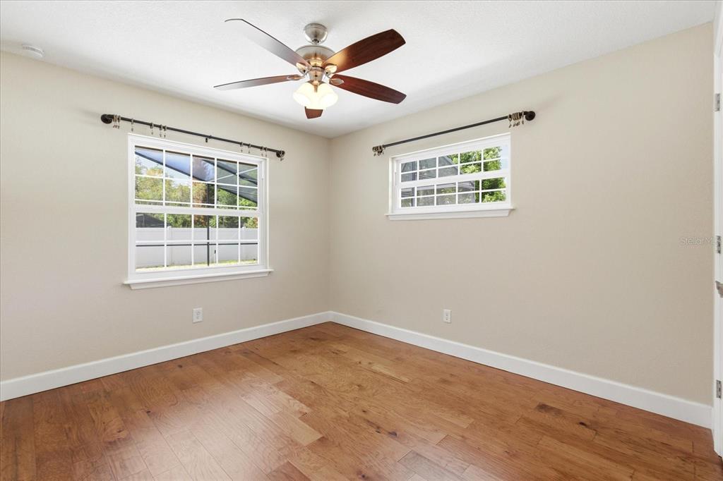 393 Wekiva Cove Road Longwood, FL 32779 - Photo 29 of 49 a view of an empty room with wooden floor and a window