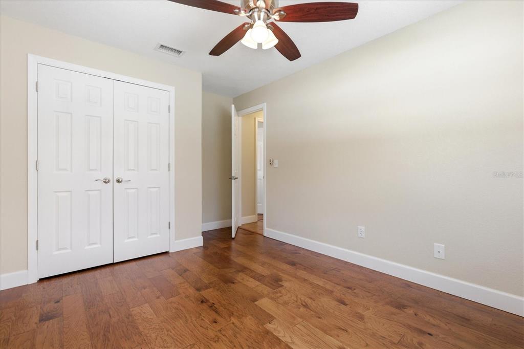 393 Wekiva Cove Road Longwood, FL 32779 - Photo 30 of 49 an empty room with wooden floor closet and windows