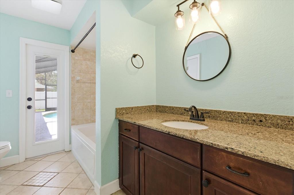 393 Wekiva Cove Road Longwood, FL 32779 - Photo 31 of 49 a bathroom with a granite countertop sink and a mirror