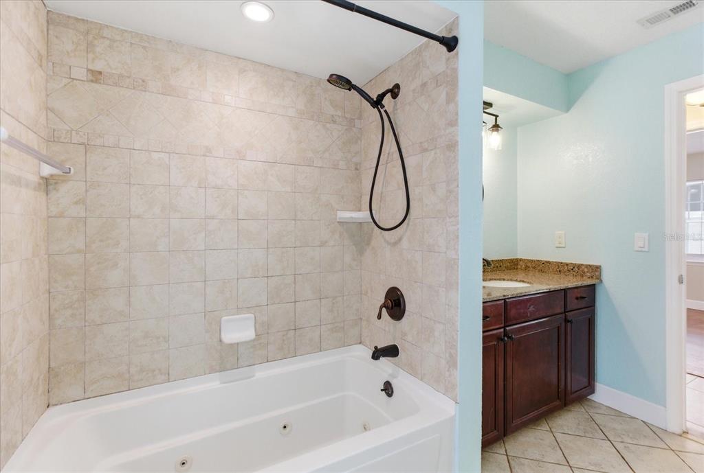 393 Wekiva Cove Road Longwood, FL 32779 - Photo 32 of 49 a bathroom with a bath tub and a shower