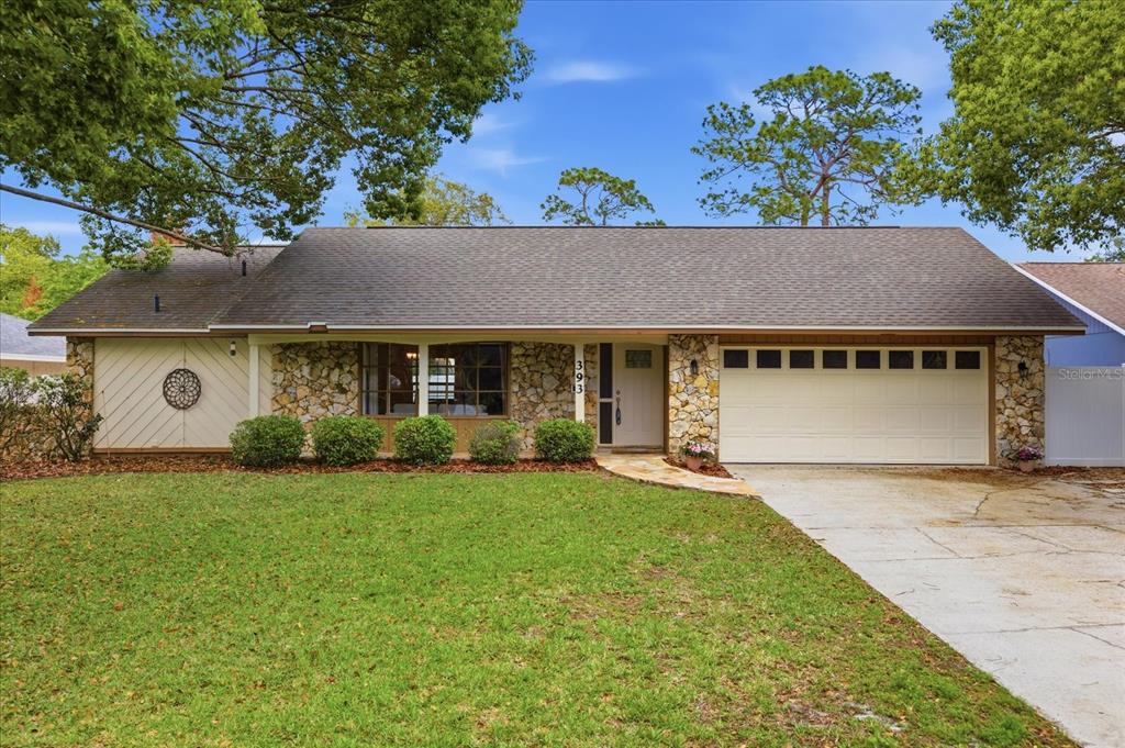 393 Wekiva Cove Road Longwood, FL 32779 - Photo 39 of 49 a front view of a house with a garden and yard