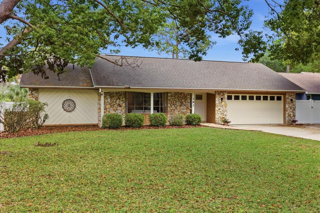 393 Wekiva Cove Road Longwood, FL 32779 - Photo 41 of 49 a view of a house with a garden