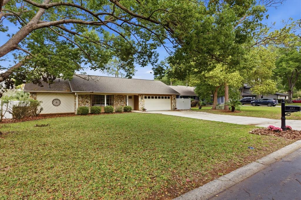 393 Wekiva Cove Road Longwood, FL 32779 - Photo 42 of 49 a front view of a house with garden