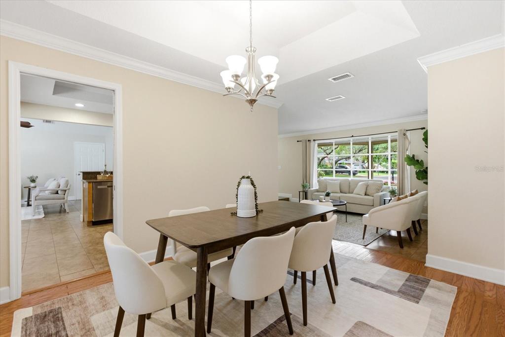 393 Wekiva Cove Road Longwood, FL 32779 - Photo 8 of 49 a view of a dining room with furniture a chandelier and wooden floor