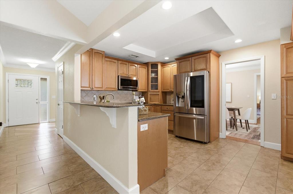 393 Wekiva Cove Road Longwood, FL 32779 - Photo 9 of 49 a kitchen with stainless steel appliances granite countertop a refrigerator and a stove top oven