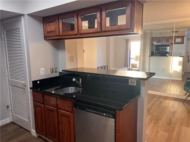 a kitchen with granite countertop a sink and a cabinets