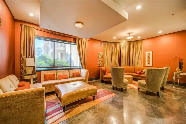 a living room with furniture and large window