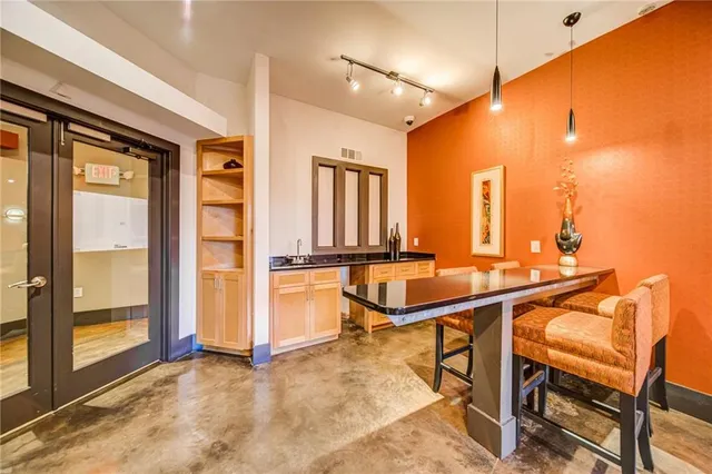 a view of a kitchen with a table and chairs