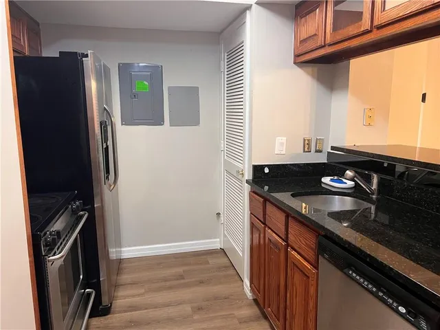 a kitchen with stainless steel appliances granite countertop a refrigerator and a sink