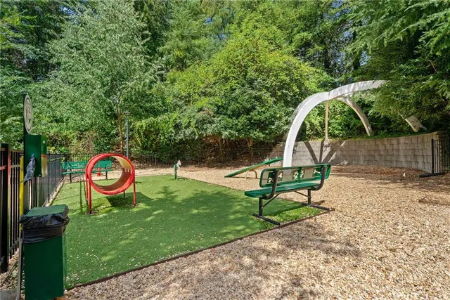 a view of a park with swings and slides