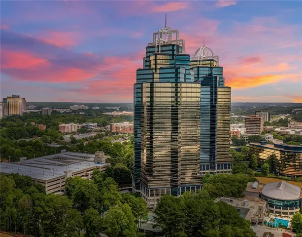 a view of a balcony with chairs and a potted plant