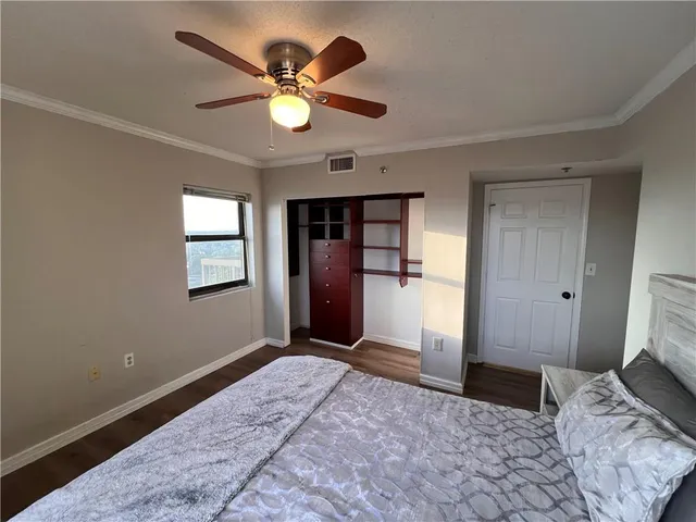 a bedroom with a large bed and a window