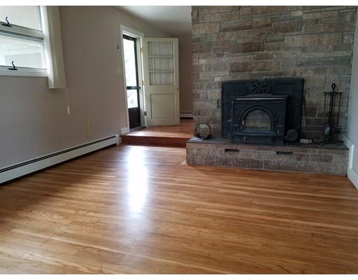 240 Alden Road Fairhaven, MA 02719 - Photo 7 of 19 a view of empty room with fireplace and wooden floor